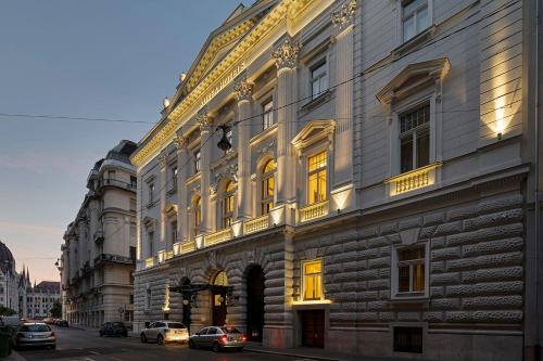 a building on a street with cars parked in front of it at Áurea Ana Palace by Eurostars Hotel Company in Budapest