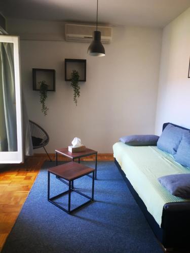 a living room with a couch and a table at Apartmani "Mary" in Grebaštica