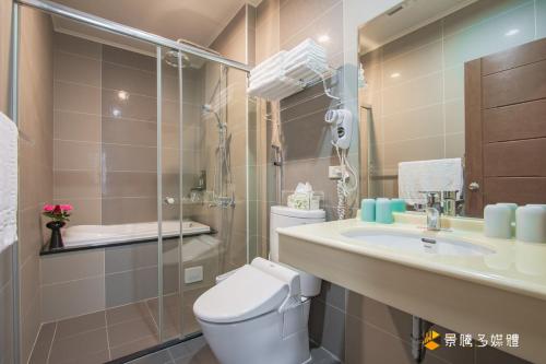 a bathroom with a toilet and a sink at Sunny No85 B&B in Toucheng