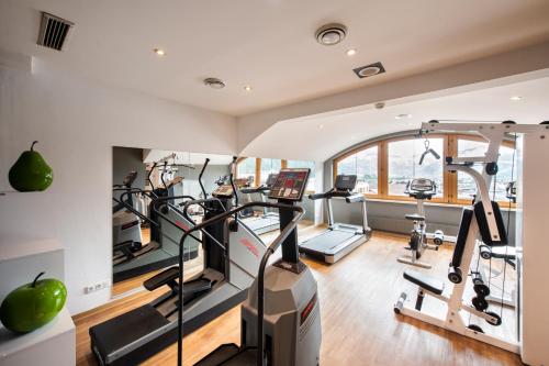 a gym with several treadmills and ellipticals at MANNI das Hotel in Mayrhofen