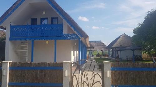 a blue and white building with a fence at Stuffino Crisan in Crisan