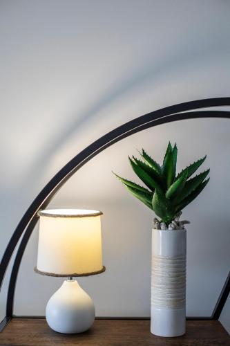 a lamp and a potted plant on a table at Azure Sea Whitsunday Resort in Airlie Beach