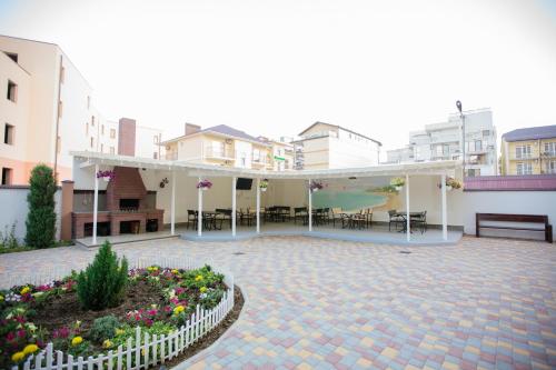 a courtyard with a pavilion with tables and chairs at Villa San-Marina in Zatoka