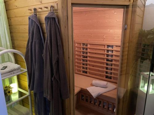 a bathroom with a sauna with towels and a mirror at Ferienwohnung Sonnenschein in Bad Hersfeld