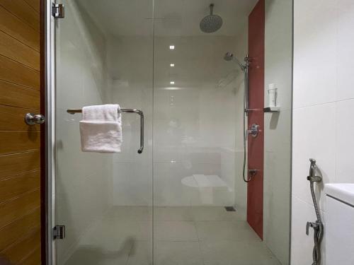 a bathroom with a shower with a glass door at Huvan Beach Hotel at Hulhumale in Hulhumale