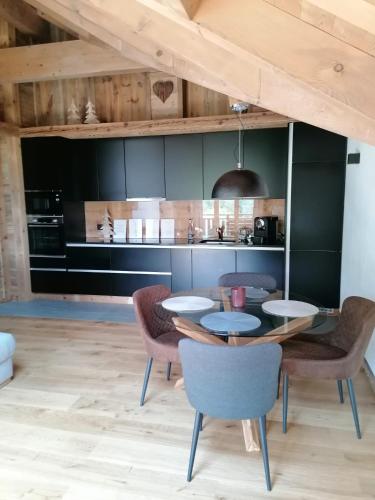 a dining room with a table and chairs at Chalet les Ecureuils Apartment Penthouse Suite in Crésuz