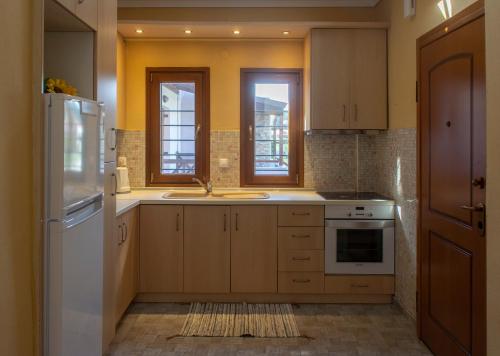 a kitchen with a sink and a refrigerator at Seaview Maisonette in Ierissos
