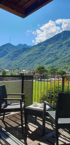 a patio with two chairs and a table with a view at Residence i Fiori in Piantedo