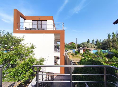 a house on a hill with a balcony at Villa Orchidea Sunrise in Zatoka