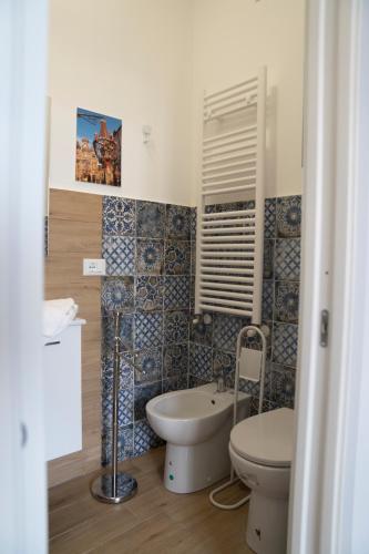a bathroom with a toilet and a bidet and a sink at B&B Socrate in Agrigento
