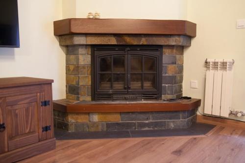 a living room with a stone fireplace at Apartamento Toran in Les