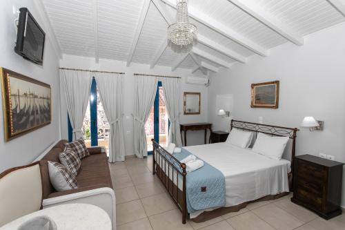 a bedroom with a bed and a couch at The Old Town hall in Parga