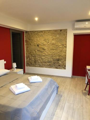 a bedroom with a bed with two towels on it at mammaCristina in Patti