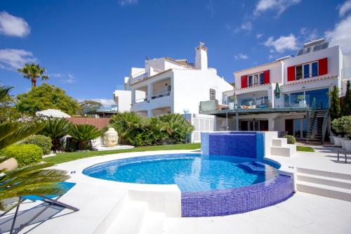 Villa con piscina frente a una casa en Luxurious BEACHFRONT VILLA de la PLAGE with private beach acces, en Albufeira