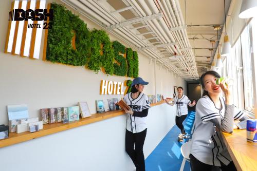 a group of people standing in a room at Dash 23 Hotel in Tainan