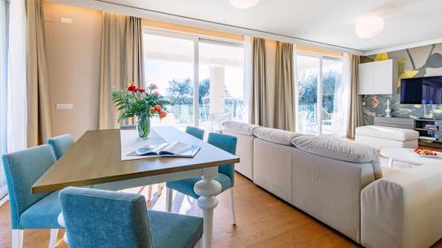a living room with a table and a couch at La Perla tra gli Ulivi 12, Emma Villas in San Vincenzo