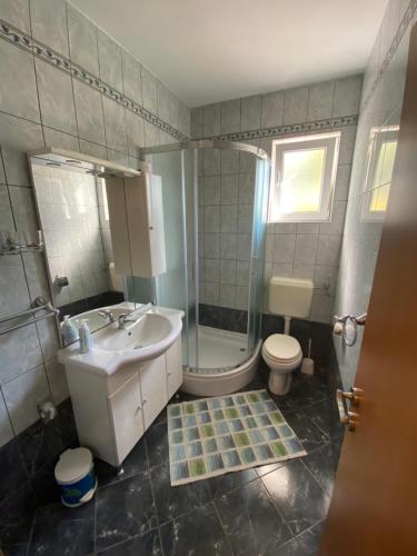 a bathroom with a sink and a toilet and a shower at Apartments Malinska - apartment 1 in Malinska