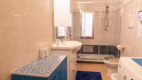 a bathroom with a sink and a toilet and a shower at Casa L'Alzoni in San Teodoro