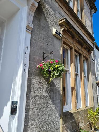 a window box with flowers on the side of a building at Ardshiel Hotel in Campbeltown