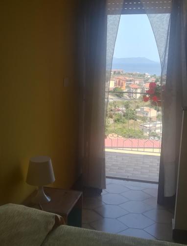 a bedroom with a bed and a window with a view at St. Michele b&b in Patti