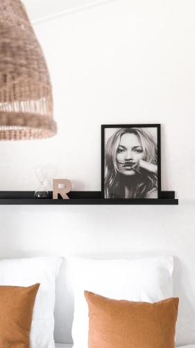 a shelf above a bed with two pictures on it at Buitenlede 7 - Suite R in Dwingeloo
