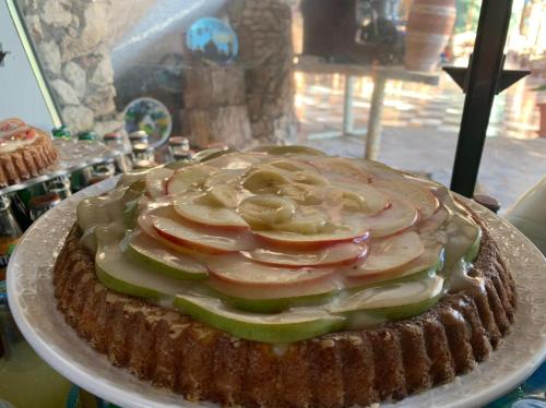 a cake sitting on a plate on a table at Hotel Leonor in Had Beni Chiker