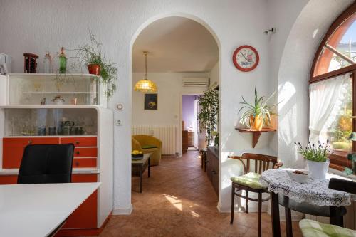 a kitchen and dining room with a table and chairs at Apartment below the stars in Rovinj
