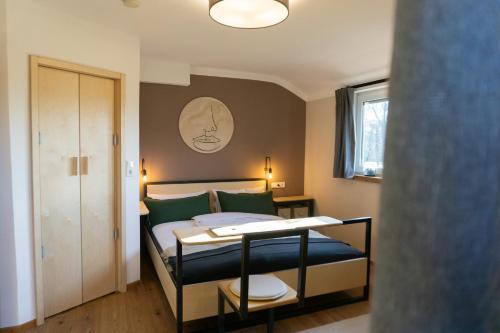 a bedroom with a bed with green pillows at Hofgut Langenborn Wohnen auf Zeit möblierte Apartments Aschaffenburg Alzenau Frankfurt in Schöllkrippen