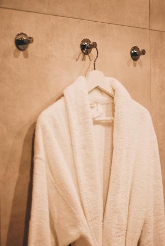 a white towel hanging on a towel rack in a shower at BOOGIE Home Kamienica Łódzka in Łódź