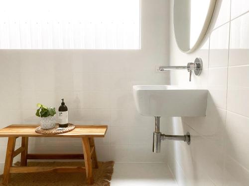 a white bathroom with a sink and a table at The Birch Studio - BOUTIQUE ACCOMODATION - CENTRAL to WINERIES and BEACHES in Leopold