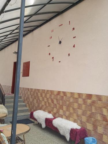 a clock on the side of a wall in a room at Vysoké Tatry Gerlaška in Gerlachov