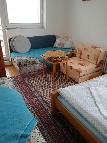 a living room with a couch and a coffee table at Vysoké Tatry Gerlaška in Gerlachov
