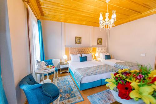 Cette chambre d'hôtel comprend deux lits, une table et des chaises. dans l'établissement Acacia Mansion Hotel, à Istanbul