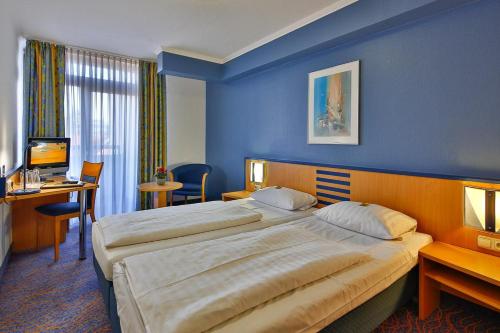 Postel nebo postele na pokoji v ubytování NP Hotel Wallis