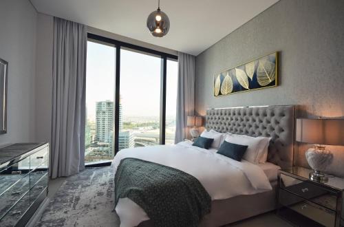 a bedroom with a large bed and a large window at KeyHost - The Address Beach Residence - K1360 in Dubai