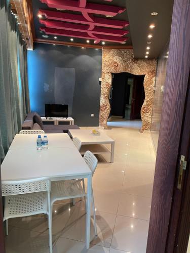 a living room with a white table and chairs at SALA Tourism Investment Furnished Apartments Family in Al Ain