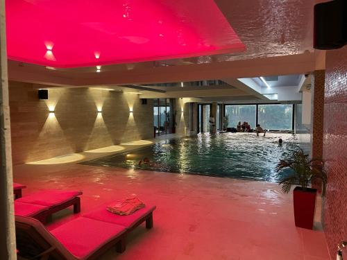 a pool in a house with a red ceiling at Vip Apartments Kopaonik in Kopaonik