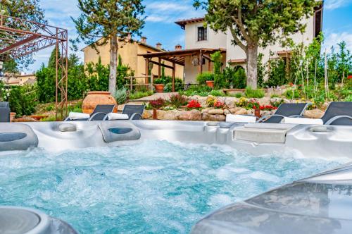 a hot tub in the backyard of a house at Villa Boccaccio in San Gimignano