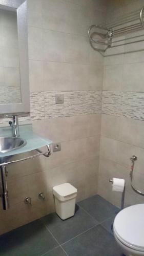 a bathroom with a toilet and a sink at La ermita 1826 in Rudaguera