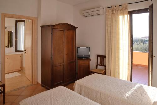 سرير أو أسرّة في غرفة في Gallura Affittacamere