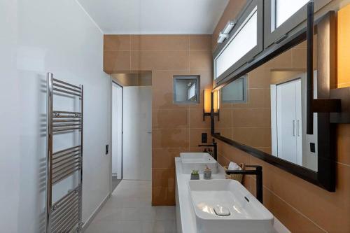 a bathroom with a tub and a sink and a mirror at Villa Theologos in Theologos