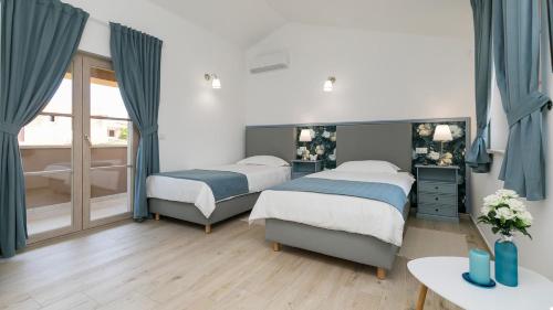 Postel nebo postele na pokoji v ubytování Villa Keli