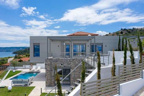 a villa with a swimming pool and a house at Villa Theologos in Theologos