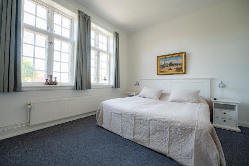 מיטה או מיטות בחדר ב-Det Gamle Posthus