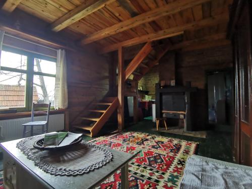 a living room with a table and a staircase at Chalet Belino sokače in Užice