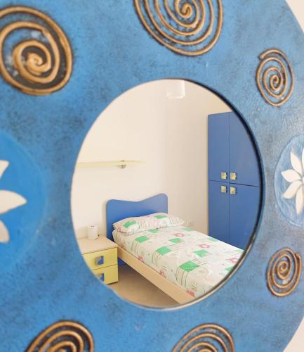 a bedroom with a bed and a mirror at Acquazzura Salento Torre Mozza in Torre Mozza