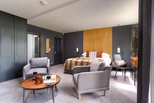 a bedroom with a bed and a table and chairs at Sweden Lodge - wonderful property in Ambleside in Ambleside