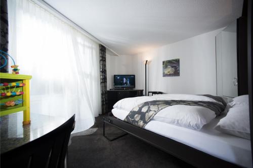 Postel nebo postele na pokoji v ubytování Grand Hôtel Les Endroits