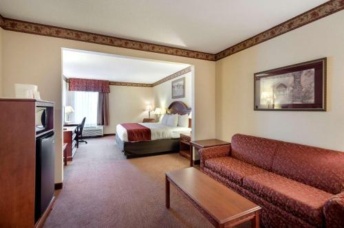 a hotel room with a bed and a couch at Quality Inn & Suites Bel Air I-95 Exit 77A in Bel Air