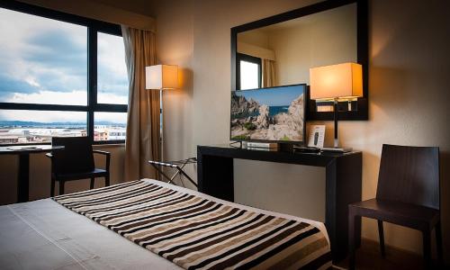 Sardegna Hotel - Suites & Restaurantにあるベッド